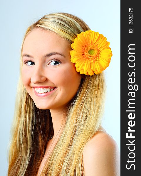 Sensual portrait of beautiful young blond woman with flower. Isolated on white background. Sensual portrait of beautiful young blond woman with flower. Isolated on white background