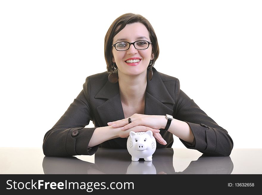 Business woman putting money coins in piggy bank