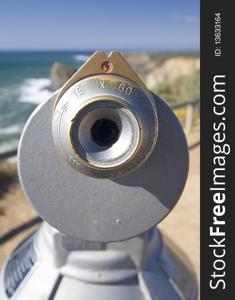 Coin operated telescope in a cosatline viewpoint overlooking the ocean (Pay per view concept)