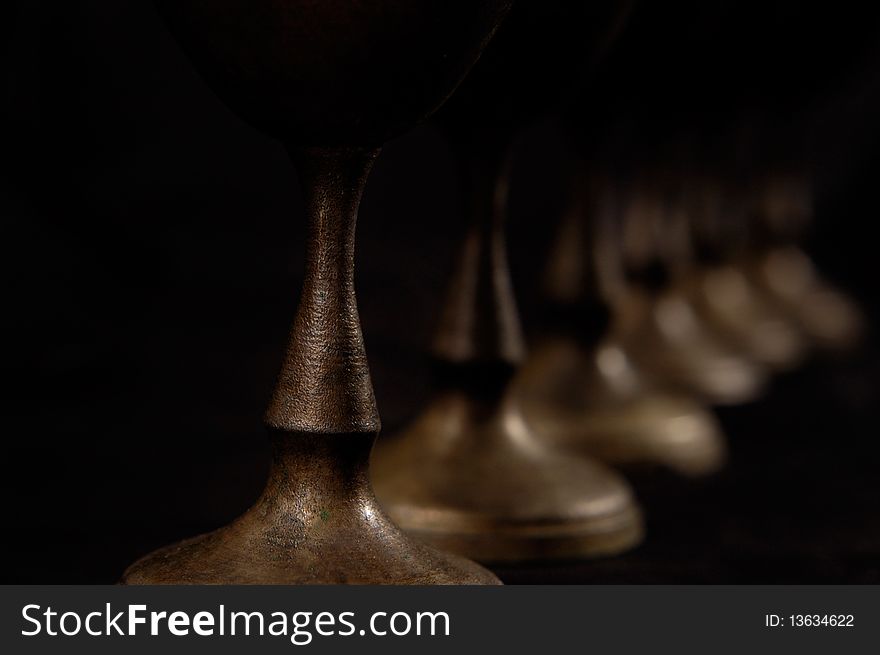 Antique decorative vintage silver stemware abstract close-up on black background. Antique decorative vintage silver stemware abstract close-up on black background