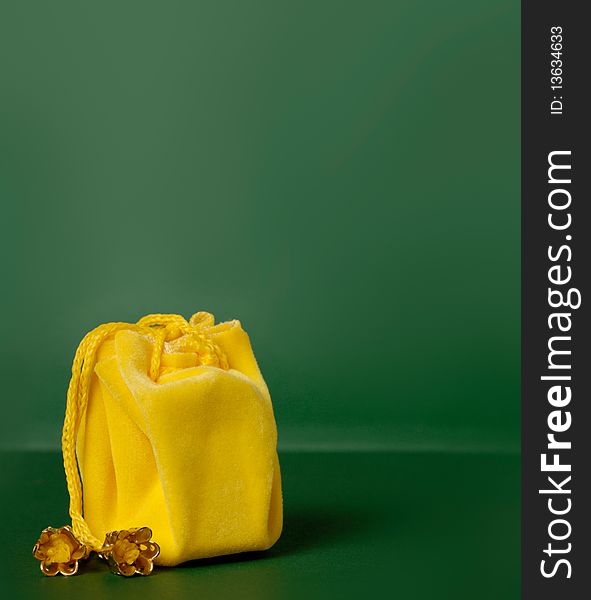 Little yellow gift sack isolated with a clipping path on green background. Little yellow gift sack isolated with a clipping path on green background