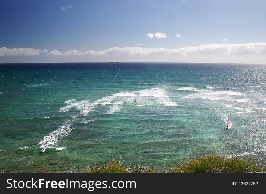 A view of people play surfing near Honolulu island sea side in Hawaii . A view of people play surfing near Honolulu island sea side in Hawaii .