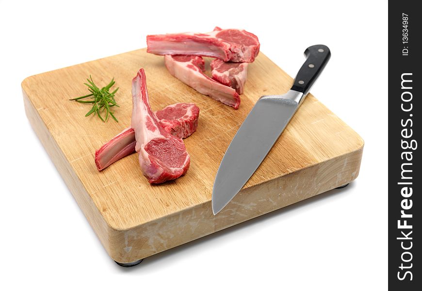 Lamb chops on a chopping board isolated against a white background