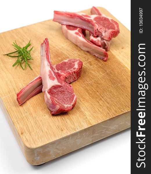 Lamb chops on a chopping board isolated against a white background