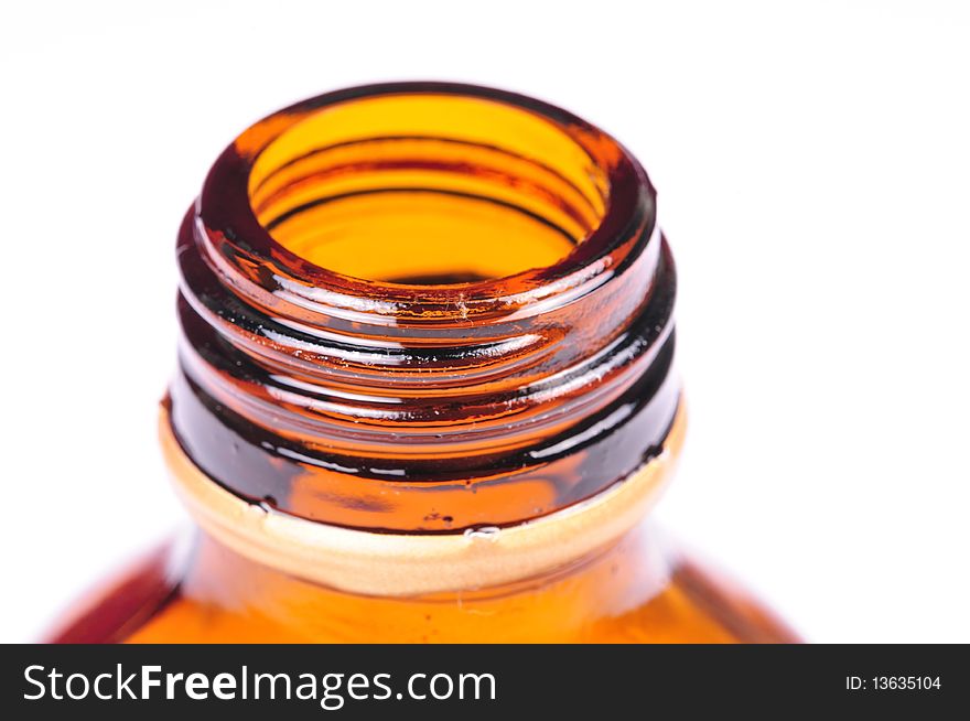 Macro shot of bottle mouth over white background.