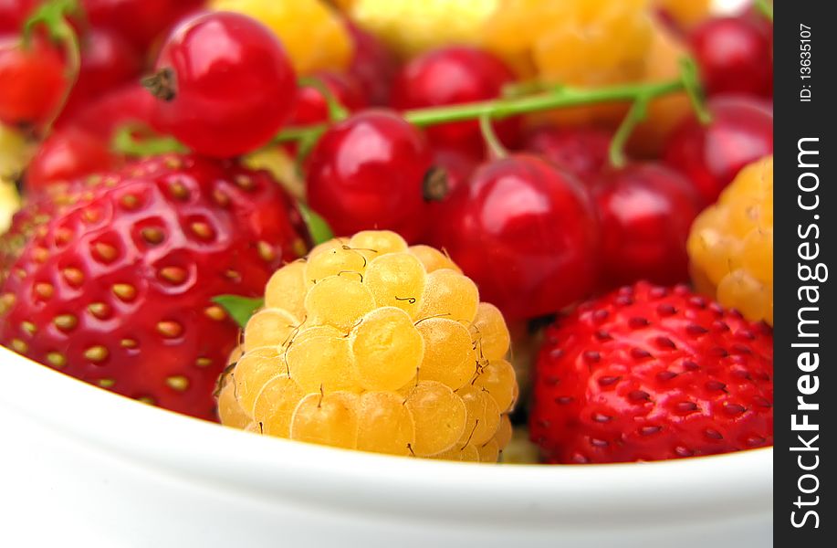 Fresh stawberries, raspberries and currants on a plate. Fresh stawberries, raspberries and currants on a plate