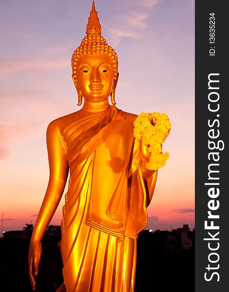 Golden standing Buddha image statue