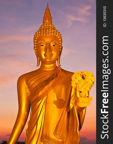 Golden standing Buddha image statue