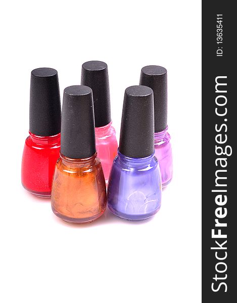 Different colored nail paints isolated on white background.