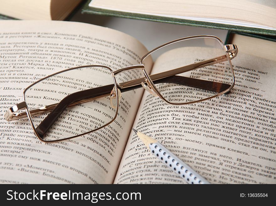 An open book and reading glasses closeup. An open book and reading glasses closeup