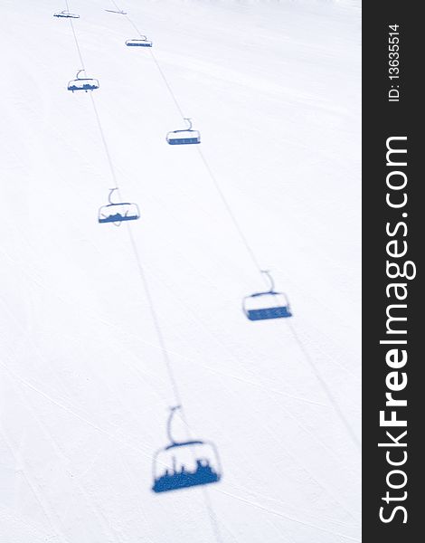 Blue shadows of chairlift on the snow. Blue shadows of chairlift on the snow
