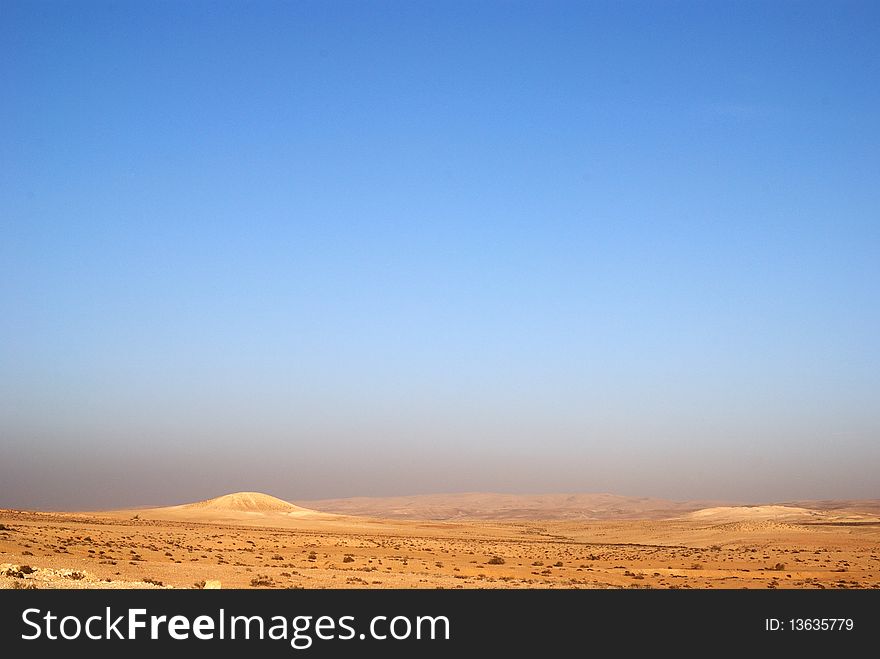 Fragment of Negev desert with mountains on a distance shot. Fragment of Negev desert with mountains on a distance shot