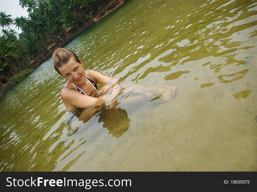 Young attractive woman having fun in tropical river. Young attractive woman having fun in tropical river