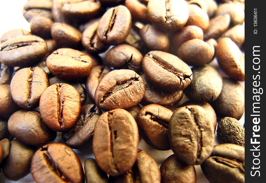 An aromatic roasted coffee beans background. An aromatic roasted coffee beans background.
