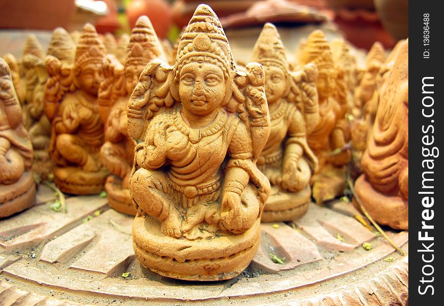 Old brown terracotta statues of indian goddess made by indian artists.