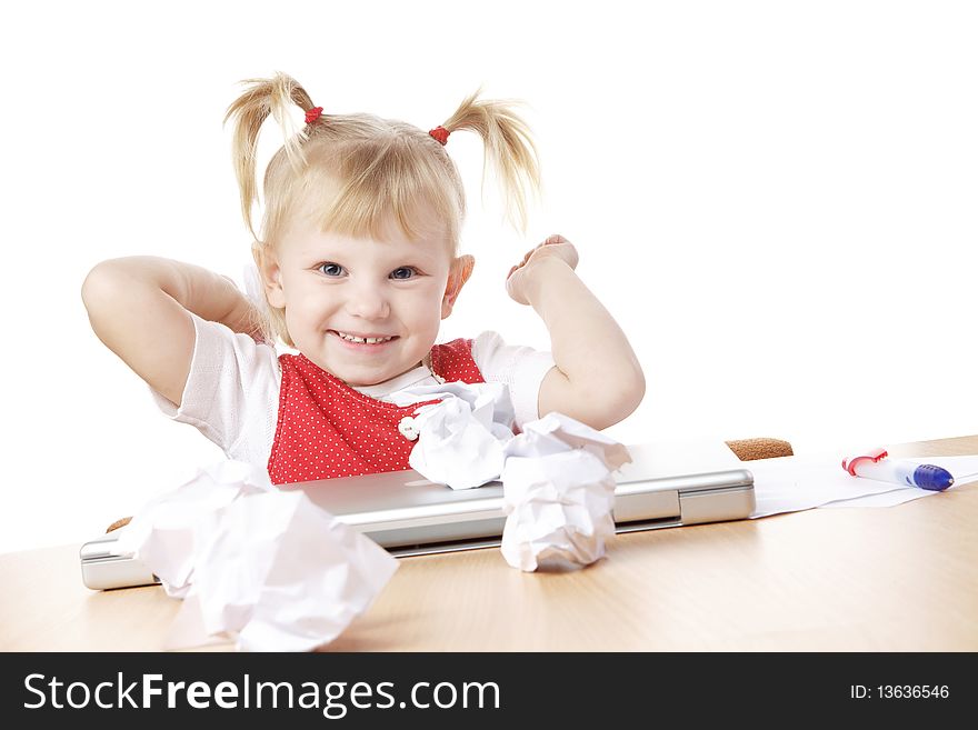 Child throwing crampled sheets of paper at the table