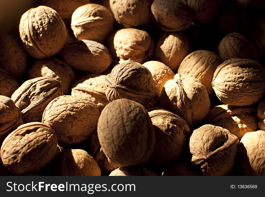 A lot of walnuts in the rays of sunlight. A lot of walnuts in the rays of sunlight