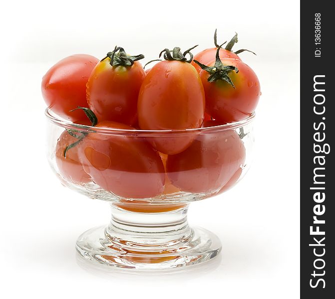 Cherry tomatoes in glass bowl white background