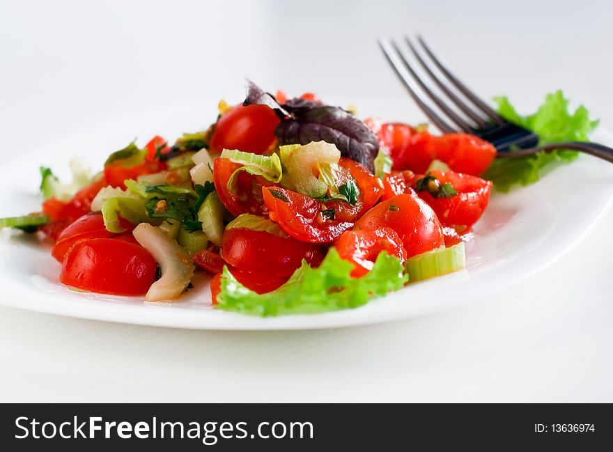 Fresh tasty tomato salad with celery and herbs