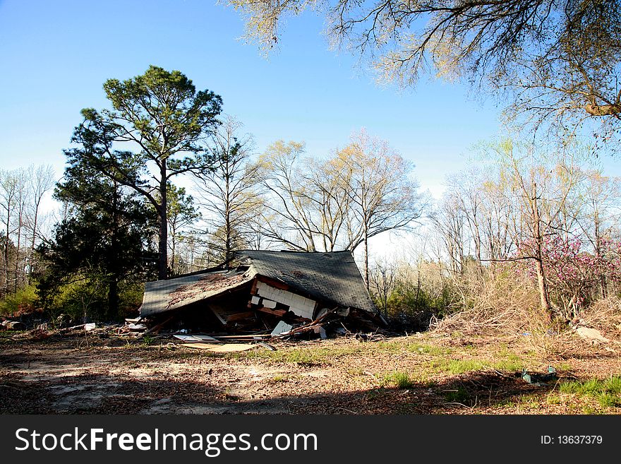 A home in the country that has collapsed down on itself. A home in the country that has collapsed down on itself.