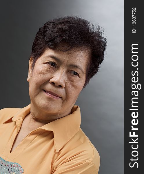Portrait of an asian woman against grey background. Portrait of an asian woman against grey background