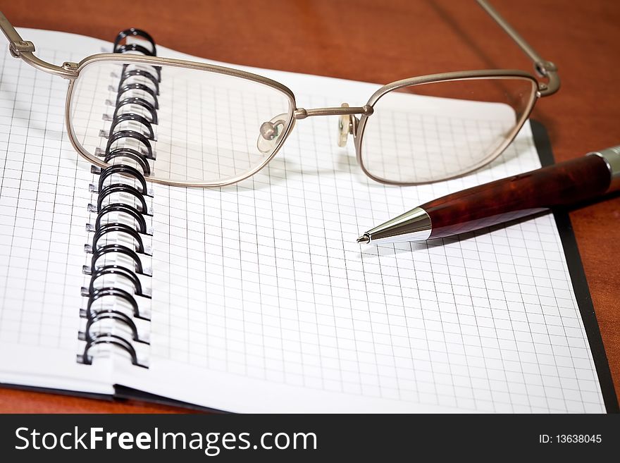 Business planner, glasses an pen