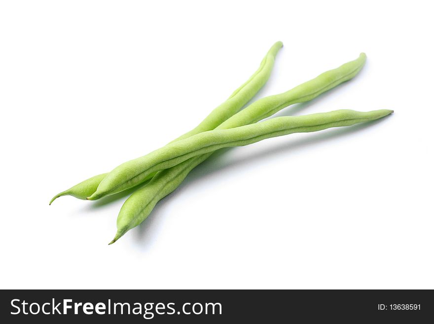 Three green french beans in isolated white background.