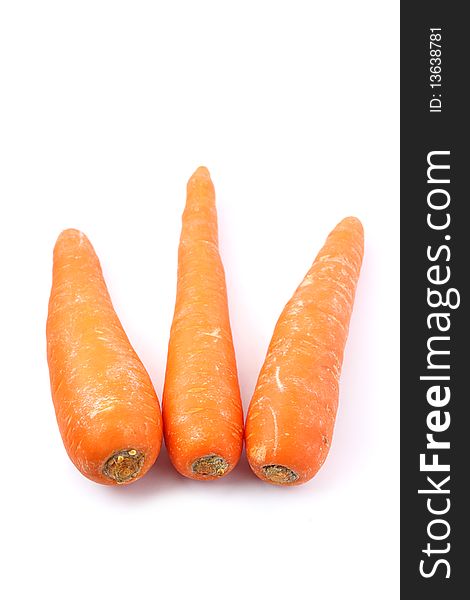Three orange carrots isolated on white background.