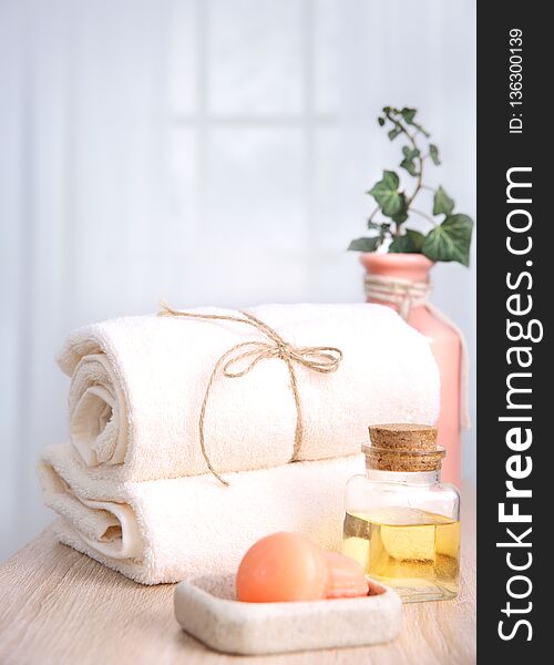 Fresh towels,soap and oil bottle on table.Hotel bathroom items,spa body care. Fresh towels,soap and oil bottle on table.Hotel bathroom items,spa body care.