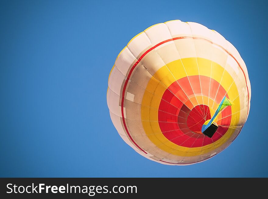 Colorful hot air balloon against the blue sky.