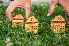 Cookies In Shape Of Small House Stand On Green Grass Stock Images