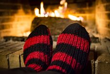 Warming Her Feet In A Fireplace Royalty Free Stock Images