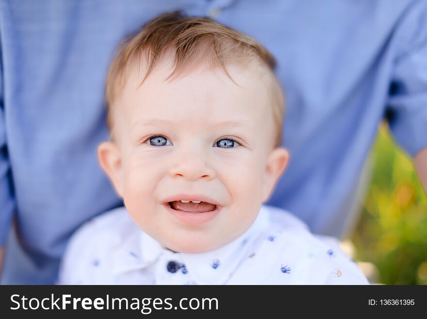 Closeup portrait of little male baby on blue t shirt background. Concept of childhood. Closeup portrait of little male baby on blue t shirt background. Concept of childhood.