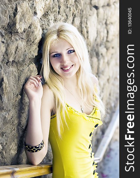 Beautiful blond girl in a yellow dress