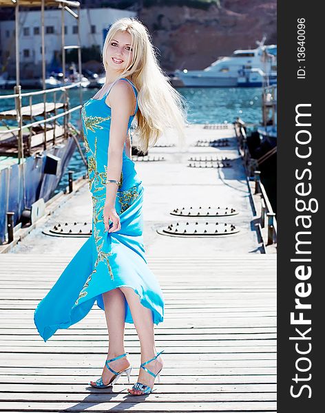 Beautiful young woman on pier