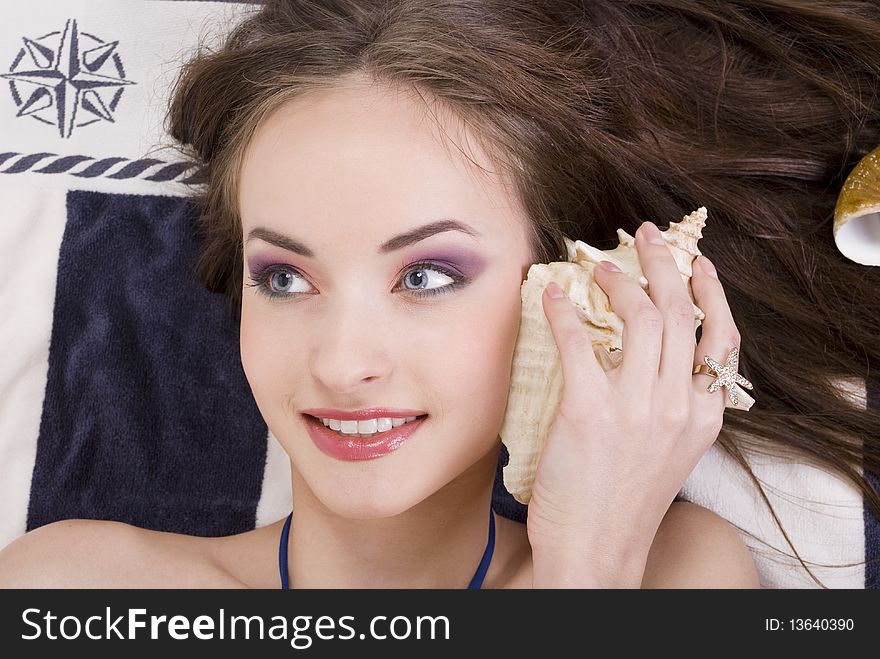 Studio portrait of a beautiful girl with seashells