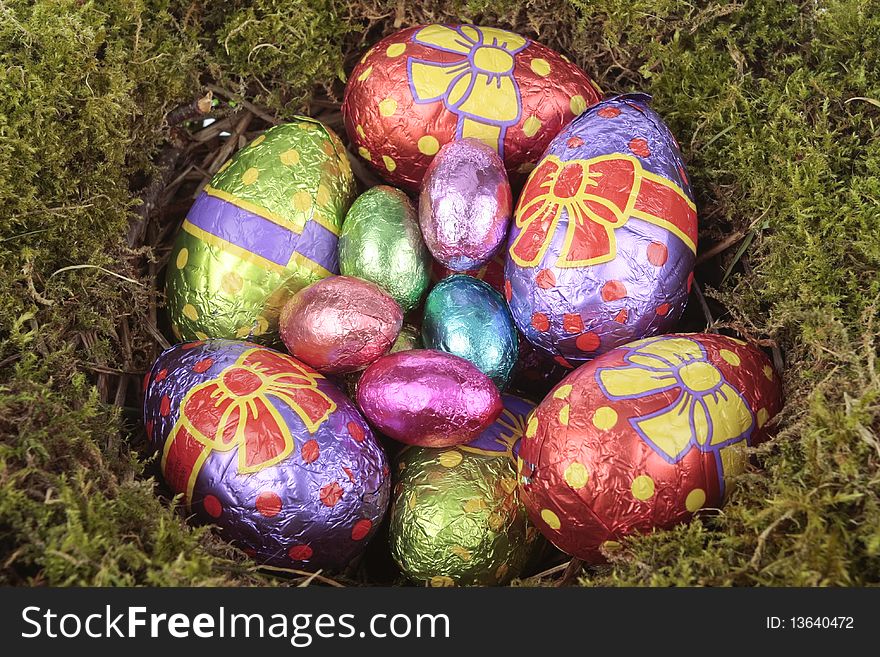Colored  eggs in bird nest over white