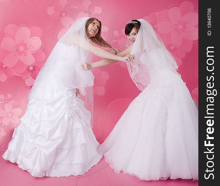 Two happy bride on a pink background