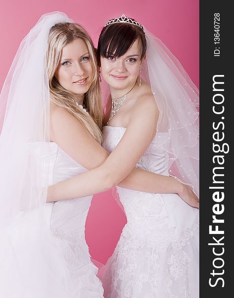 Two happy bride on a pink background