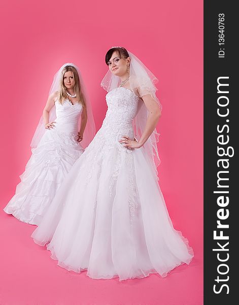 Two happy bride on a pink background