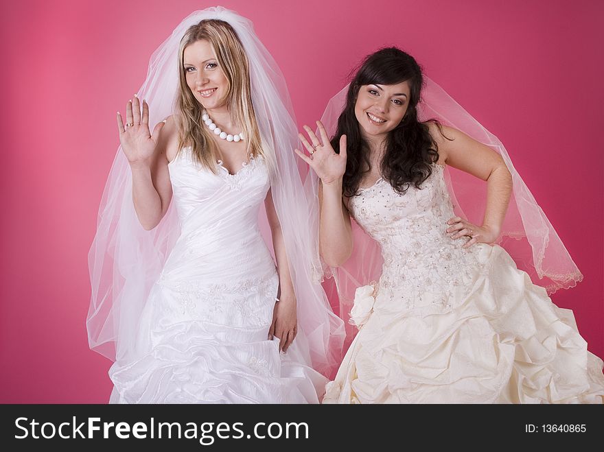 Two happy bride on a pink background