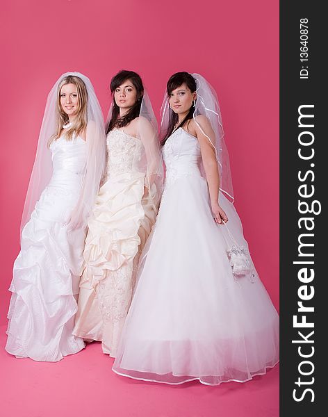 Three happy bride on a pink background