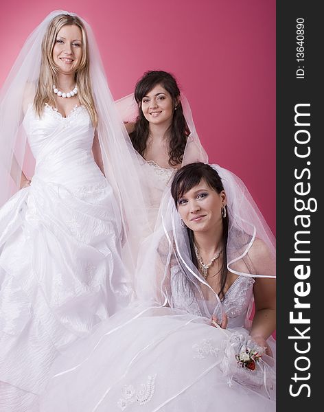 Three happy bride in studio