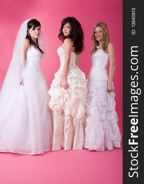 Three happy bride on a pink background