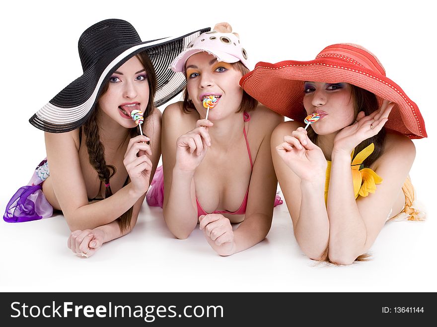 Three happy girls in a summer dress with candy. Three happy girls in a summer dress with candy