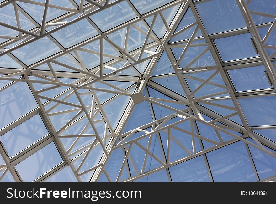 Contemporary roof structure with glass and clear blue sky