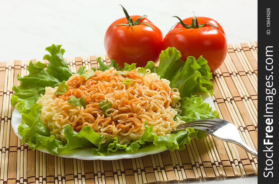 Dish of noodles on lettuce leaf