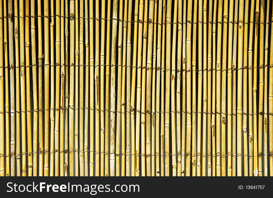 A vertical bamboo fence background. A vertical bamboo fence background