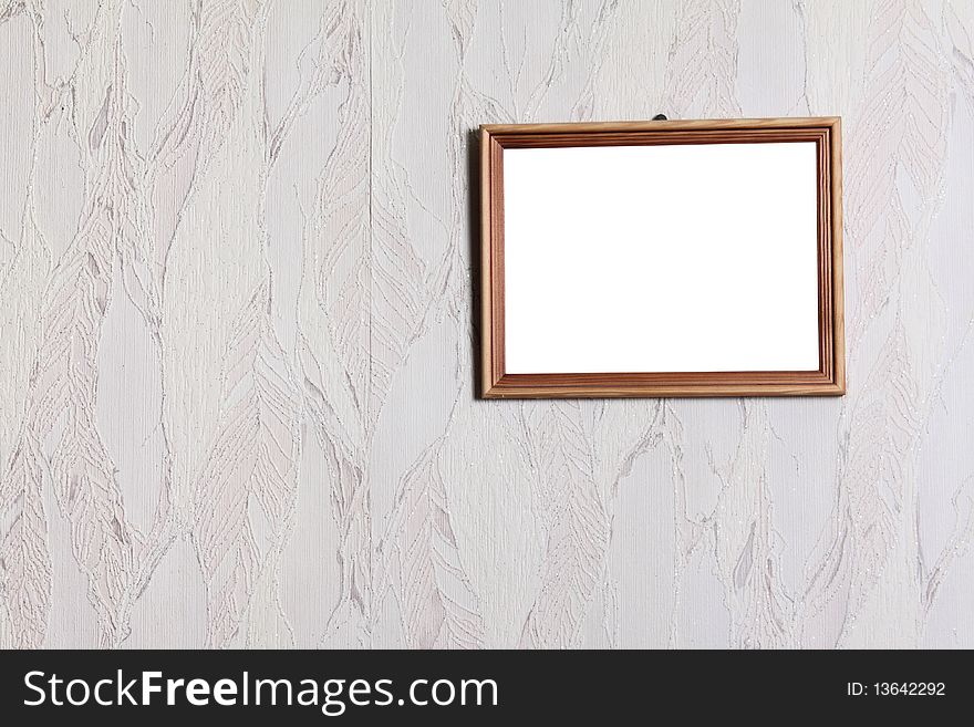 Simple wooden framework on a wall pasted over with wall-paper