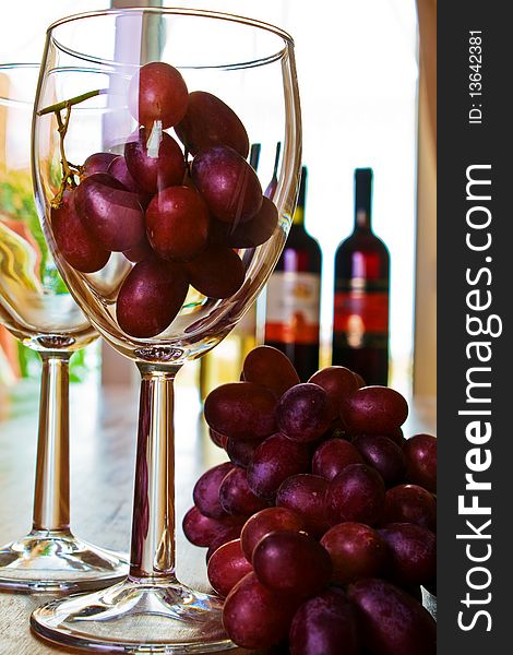 Red grapes in a glass wine concept image. Red grapes in a glass wine concept image